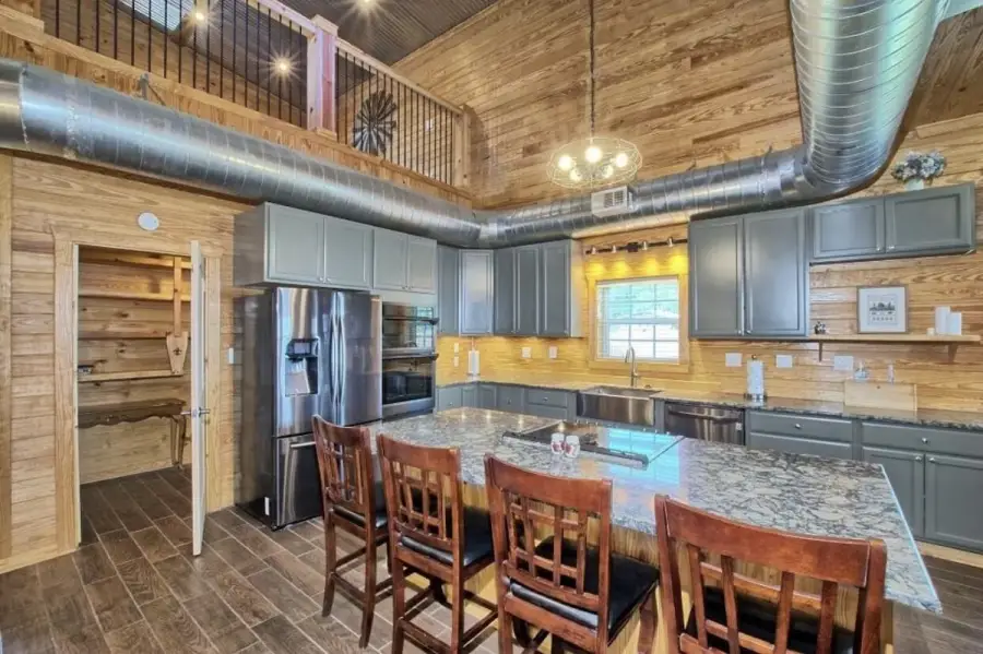 Large kitchen with double ovens, quartz counter tops and huge pantry.
